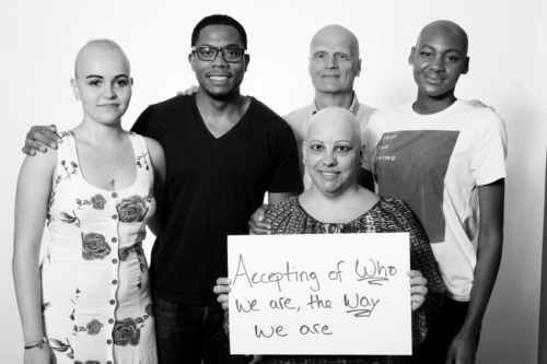 adults with alopecia areata holding a sign asking for acceptance